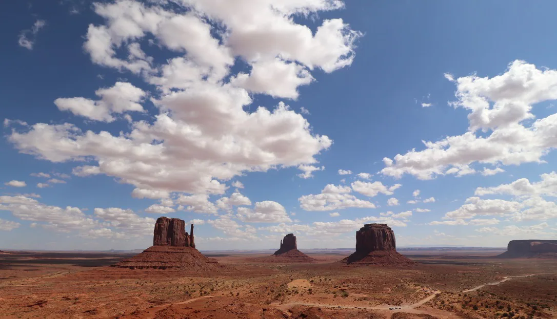 Monument Valley buttes beneath a bright blue sky