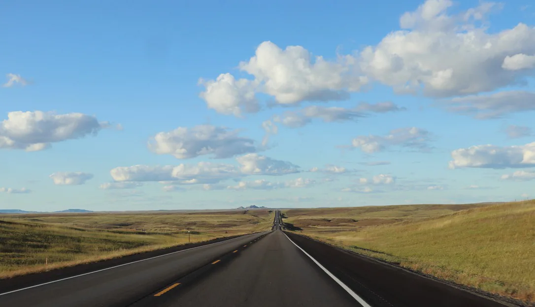 Open highway crossing a broad desert landscape